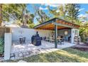 Covered outdoor dining area complete with BBQ, dining table, and outdoor kitchen at 472 Pine St, Tarpon Springs, FL 34689