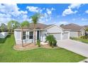 Attractive home with a 3-car garage, beautiful landscaping and a well-maintained lawn at 6307 113Th E Ter, Parrish, FL 34219