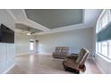 Spacious living room with natural light, tray ceiling and neutral paint, complete with comfortable furniture at 7056 Landover Blvd, Spring Hill, FL 34608