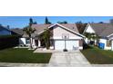 Beautiful single-story home with a well-manicured lawn and an attached two-car garage at 8731 Boysenberry Dr, Tampa, FL 33635