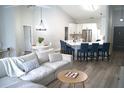 Bright living room featuring cathedral ceilings, modern decor, and an adjacent kitchen island with bar seating at 8731 Boysenberry Dr, Tampa, FL 33635