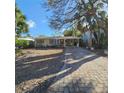 Charming one-story home featuring a welcoming front porch and brick-paved driveway at 115 11Th Ave, Indian Rocks Beach, FL 33785