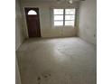 Bright living room with large window and a classic front door at 115 11Th Ave, Indian Rocks Beach, FL 33785