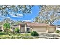 Charming single-story home boasts a meticulously landscaped front yard and a spacious three-car garage at 140 Sage Cir, Crystal Beach, FL 34681