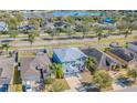 Aerial view of a two-story home with neutral paint, two-car garage, and landscaping, near a community lake at 2111 Roanoke Springs Dr, Ruskin, FL 33570