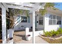 Inviting white front porch featuring seating and a view of the home's well-maintained exterior at 4415 4Th S Ave, St Petersburg, FL 33711