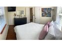 Bedroom featuring hardwood floors, light walls, and a full-length mirror at 4710 22Nd N Ave, St Petersburg, FL 33713