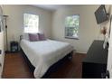 Well-lit bedroom with hardwood floors and a contemporary black dresser at 4710 22Nd N Ave, St Petersburg, FL 33713