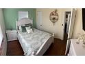 Cozy bedroom with hardwood floors, a decorative shelf, and a comfortable-looking bed at 4710 22Nd N Ave, St Petersburg, FL 33713