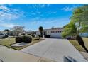 Lovely single-story home with a well-kept lawn, driveway, and neatly trimmed bushes at 612 Allegheny Dr, Sun City Center, FL 33573