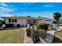 Charming home showcasing a landscaped front yard with white rock and mature Bird of Paradise at 612 Allegheny Dr, Sun City Center, FL 33573