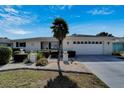 Attractive single-story residence featuring a pristine lawn, manicured landscaping, and a spacious driveway at 612 Allegheny Dr, Sun City Center, FL 33573