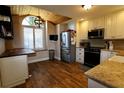 Bright kitchen with stainless steel appliances, wood-look floors, butcher block island, and vaulted wood ceilings at 6307 Songbird Way, Tampa, FL 33625