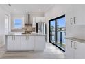 Modern kitchen with island, stainless appliances, and a view of the water at 777 Gran Kaymen Way, Apollo Beach, FL 33572