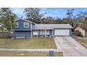 Charming two-story home featuring a well-maintained lawn and inviting facade under a blue sky at 8019 Capwood Ave, Temple Terrace, FL 33637