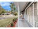 Inviting front porch with manicured landscaping, providing a warm welcome to this charming home at 8019 Capwood Ave, Temple Terrace, FL 33637