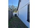 Shows a clean exterior with white paint, black trim, and an air conditioning unit at 8706 N Boulevard, Tampa, FL 33604