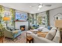 Bright living room featuring a cozy fireplace, stylish furniture, and decorative curtains at 114 27Th N Ave, St Petersburg, FL 33704