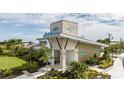 Modern community clubhouse featuring a stone facade, contemporary design, landscaping, and Windwater Club signage at 12316 49Th E St, Parrish, FL 34219