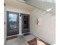 View of entryway with front doors, welcome mats, and exterior lighting at 129 W Cypress Ct, Oldsmar, FL 34677