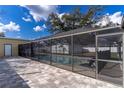 Exterior shot of the screened pool, with ample patio space and a charming backyard area at 13508 Greenleaf Dr, Tampa, FL 33613