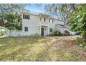 Charming two-story home with grey siding, brick accents, balcony, and a well-manicured lawn at 14803 Tulip Dr, Tampa, FL 33613