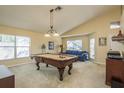 Bright game room featuring a pool table, comfortable seating, and plenty of natural light at 1788 Biarritz Cir, Tarpon Springs, FL 34689