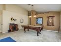 Spacious game room with a classic pool table under pendant lighting, perfect for entertaining at 1788 Biarritz Cir, Tarpon Springs, FL 34689