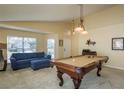 Inviting game room complete with a billiard table, cozy sofa, and stylish lighting fixtures at 1788 Biarritz Cir, Tarpon Springs, FL 34689