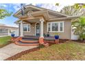 Quaint single-Gathering home with a classic porch, columns, and a beautiful tan exterior at 1924 W Carmen St, Tampa, FL 33606