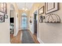 Inviting hallway with hardwood floors, decorative lighting, and archway entrance to other rooms at 1924 W Carmen St, Tampa, FL 33606