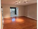 Bright living room showcasing hardwood floors and neutral walls at 2209 Canterbury Ln, Sun City Center, FL 33573