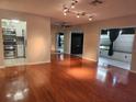 Spacious living room featuring gleaming hardwood floors and ample natural light at 2209 Canterbury Ln, Sun City Center, FL 33573