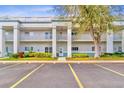 Exterior shot of condo building featuring balconies, lush landscaping, and ample parking at 2298 Americus E Blvd # 6, Clearwater, FL 33763