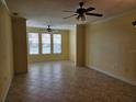 Spacious living room with tile floors, ceiling fans, and large windows for plenty of natural light at 2755 Via Capri Dr # 1215, Clearwater, FL 33764