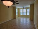 Open-concept living room with tile floors, neutral paint, and bright windows for lots of natural light at 2755 Via Capri Dr # 1215, Clearwater, FL 33764