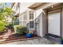 Close up of home's entrance with neat landscaping and a tidy walkway at 2786 Countryside Blvd # 2, Clearwater, FL 33761