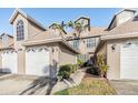 Charming townhome showcasing a well-kept lawn and front entryway at 2786 Countryside Blvd # 2, Clearwater, FL 33761