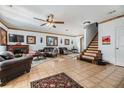 Spacious living room featuring a fireplace, tile flooring, and staircase at 2786 Countryside Blvd # 2, Clearwater, FL 33761