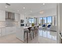 Modern kitchen features an island with seating, stainless steel appliances, and a view of the city at 301 1St S St # 2104, St Petersburg, FL 33701