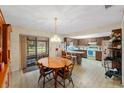 Charming eat-in kitchen featuring wood cabinets, a breakfast bar, and a sliding door leading to the outside at 38928 Tall Dr, Zephyrhills, FL 33540