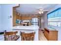 Cozy kitchen featuring laminate countertops, wood cabinets, and stainless steel appliances at 4529 Olive Dr, Zephyrhills, FL 33542