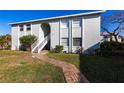 Well-maintained condo with a private entrance and neatly manicured lawn at 522 Pine Ave # 6A, Anna Maria, FL 34216