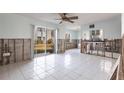 Spacious living room featuring tile floors, a sliding door, and natural light at 522 Pine Ave # 6A, Anna Maria, FL 34216