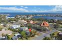 Aerial view of a neighborhood with waterfront homes, lush greenery, and mature trees at 601 Cordova Ne Blvd, St Petersburg, FL 33704