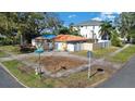 Charming single-story home with a red tile roof, a white fence, and mature trees on a corner lot at 601 Cordova Ne Blvd, St Petersburg, FL 33704
