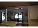 Open floor plan with a view from the kitchen to the dining room, and modern pendant lighting at 6188 Pinehurst Dr, Spring Hill, FL 34606