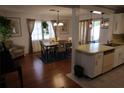 The dining room adjacent to the kitchen features hardwood floors and modern decor at 6188 Pinehurst Dr, Spring Hill, FL 34606