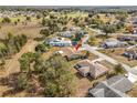 An aerial view of a house and the surrounding neighborhood. The house has a brown roof at 7078 Lexington Cir, Brooksville, FL 34602