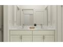 Modern bathroom featuring double sinks with white marble countertop, white cabinetry and a shower at 7516 E 116Th St, Palmetto, FL 34221